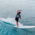 Man in Black Wetsuit Surfing on Blue Sea